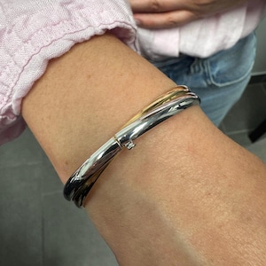 14K Two Tone Gold Double Row crossover Bangle worn on the wrist, side view