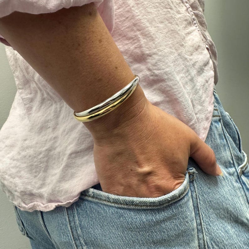 14K Two Tone Gold Double Row crossover Bangle worn on the wrist, close view