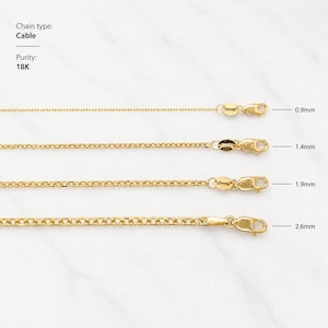May include: Four gold cable chain necklaces of varying thicknesses, ranging from 0.9mm to 2.6mm, are displayed against a white background. The chains are 18K gold and feature lobster claw clasps. The chain type is cable.