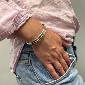 14K Two Tone Gold Double Row crossover Bangle worn on the wrist