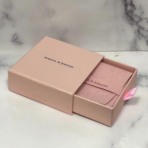 Marina M Jewelry pink gift box with a jewelry pouch, included with every order