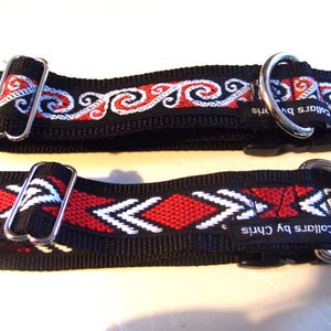 May include: Two black dog collars with red and white woven designs. The top collar has a white and red swirl pattern. The bottom collar has a white and red arrow pattern. Both collars have silver hardware and the text "Collars by Chris" on the black strap.