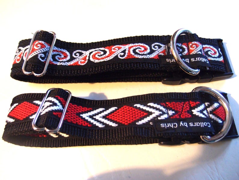May include: Two black dog collars with red and white woven designs. The top collar has a white and red swirl pattern. The bottom collar has a white and red arrow pattern. Both collars have silver hardware and the text "Collars by Chris" on the black strap.