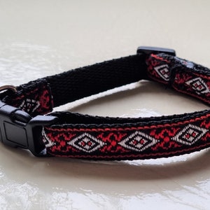 May include: A black and red patterned dog collar with a black plastic buckle.