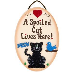 A Spoiled Cat lives here wooden painted hanging sign