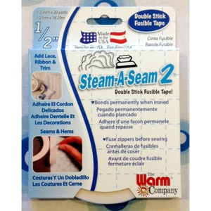 May include: A blue and white package of Steam-A-Seam 2 double stick fusible tape. The package shows a close-up of the tape and an iron. The text on the package reads "Steam-A-Seam 2 Double Stick Fusible Tape!" and "Bonds permanently when ironed". The package is made in the USA.