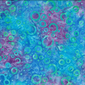 May include: Abstract fabric with a blue and purple background. The fabric is covered in a pattern of green circles and dots.