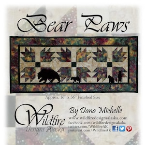 May include: A rectangular quilt with the text "Bear Laws" and bear paw prints. The quilt features a bear family silhouette and measures approximately 16 inches by 36 inches.