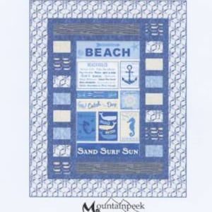 May include: A quilt pattern titled "Grand Stand" with a beach theme. The quilt design features blue and white squares with beach-related imagery and text, including the words "BEACH" and "SAND SURF SUN". The pattern is by Kari Nichols.