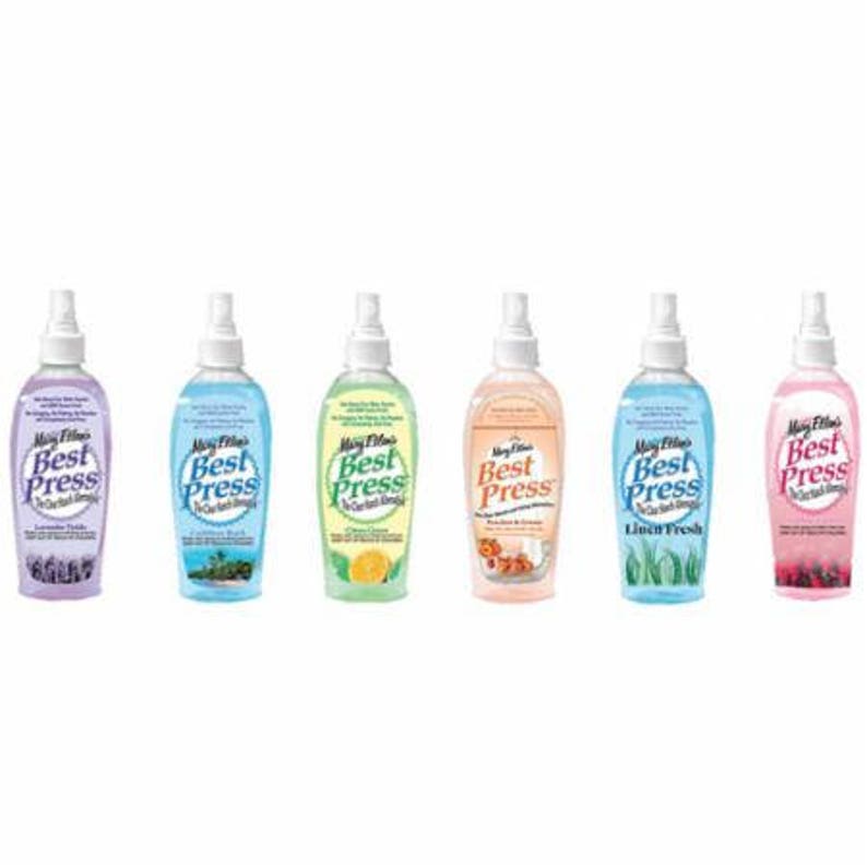 May include: Six bottles of Mary Ellen's Best Press starch in various scents. Each bottle has a white spray nozzle and a label with the brand name and scent description. Scents include Lavender Fields, Linen Fresh, and others.