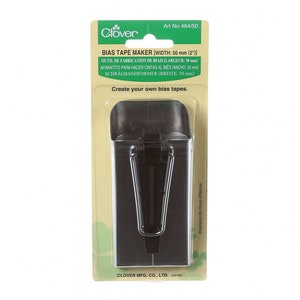 May include: A black bias tape maker tool packaged on a green and white background. The package includes the text "Clover Bias Tape Maker (Width: 50 mm (2'))" and "Create your own bias tapes."