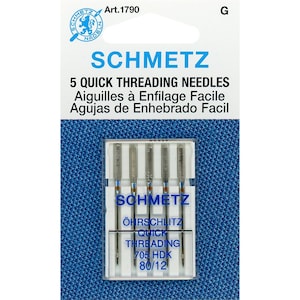 May include: A package of five Schmetz quick threading sewing needles in a clear plastic case. The needles are silver and the packaging is blue and white with the text "Schmetz Quick Threading 705 HDK 80/12".