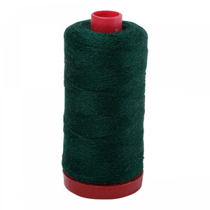 May include: A cylindrical spool of dark forest green thread featuring a textured, fibrous appearance. The spool is held in place by a bright red plastic base and a matching red plastic cap at the top, providing a clear contrast to the deep green color.
