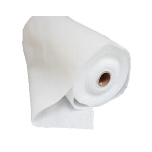 Puede incluir: Un rollo de tela blanca, parcialmente desenrollado, revelando la textura y el grosor del material. El núcleo del rollo es visible, con un tubo de cartón marrón. La tela parece suave y ligera.