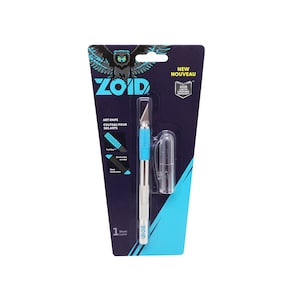 May include: A blue and silver Zoid art knife with a single blade. The packaging features a black and white owl logo and the text "NEW NOUVEAU" and "ZOID LIFETIME WARRANTY".