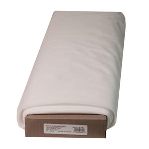 May include: A bolt of white 100% polyester French Fuse interfacing fabric wrapped around a cardboard core. The label reads STAPLE SEWING AIDS, 25 YDS/22.8 METER, 60 IN/152 CM, and includes a barcode. The fabric has a smooth, semi-sheer texture.