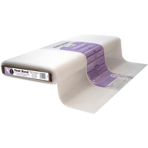 May include: A roll of HeatnBond Ultra Soft Fusible interfacing for batik fabrics. The roll is white with a purple and white label. The label includes the HeatnBond logo and product information. The roll is approximately 10 inches wide and 15 yards long.