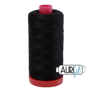 May include: A spool of black sewing thread wound onto a cylindrical core with a bright red plastic top and base. The base features embossed text and the brand logo AURIfil is displayed in the lower right corner of the image.