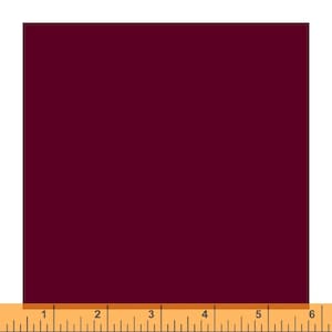 May include: A solid square of deep burgundy fabric. A wooden ruler is at the bottom of the image, with measurements in inches.
