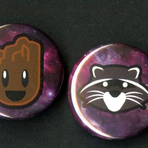 May include: Two round buttons with a galaxy background. The first button features a brown cartoon character with a happy face. The second button features a black cartoon raccoon with a white face.
