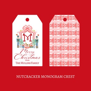 May include: A white gift tag with a pink and red nutcracker design. The tag features a monogram "M" and the text "Merry Christmas from THE MULLINS FAMILY". The back of the tag has a pink and white checkered pattern.