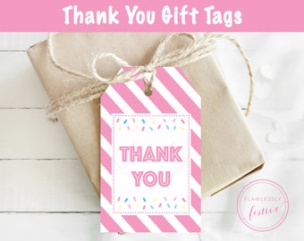 May include: Pink and white striped gift tag with the text "Thank You" in a white circle surrounded by colorful sprinkles. The tag is tied with twine to a brown gift box.