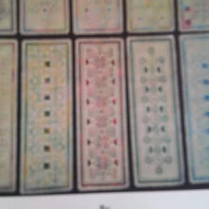 May include: A set of nine rectangular cards with different patterns. Each card has a white background with a colorful pattern in the center. The patterns are geometric and abstract.
