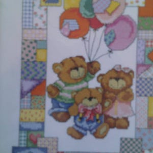 May include: Three teddy bears holding colorful balloons against a patchwork background. The bears are wearing different outfits, including a striped shirt, a blue overall, and a pink dress. The balloons are red, orange, yellow, green, blue, and pink.