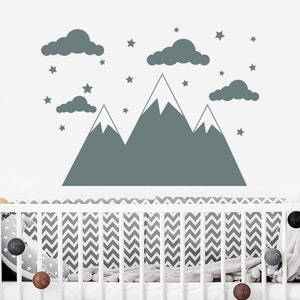 May include: A gray mountain range wall decal with white snow peaks and clouds. The decal is surrounded by small gray stars.