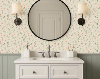 May include: A bathroom scene with a white vanity, a round black mirror, and floral wallpaper. The wallpaper has a cream background with pink flowers and green leaves. Two sconces with beige shades are on either side of the mirror.