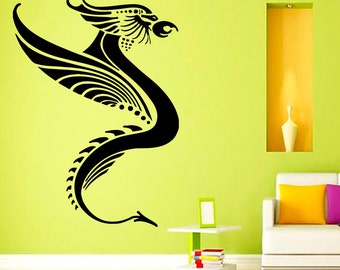 May include: Black and white silhouette of a dragon with wings outstretched, on a light green wall. The dragon is stylised with geometric shapes and lines.