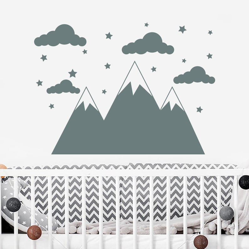 May include: A gray mountain range wall decal with white snow peaks and clouds. The decal is surrounded by small gray stars.
