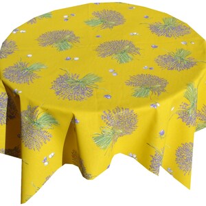 May include: A yellow round tablecloth with a lavender floral pattern. The tablecloth has a scalloped edge and is made of a soft, durable fabric.