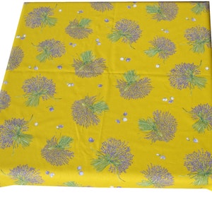 May include: Yellow tablecloth with a lavender floral pattern. The tablecloth is made of cotton and has a woven texture.