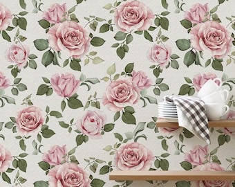 May include: Wallpaper featuring a repeating pattern of dusty pink roses and green leaves on a cream background. Two wooden shelves are mounted on the right side, holding a stack of white ceramic bowls and a grey and white chequered cloth.