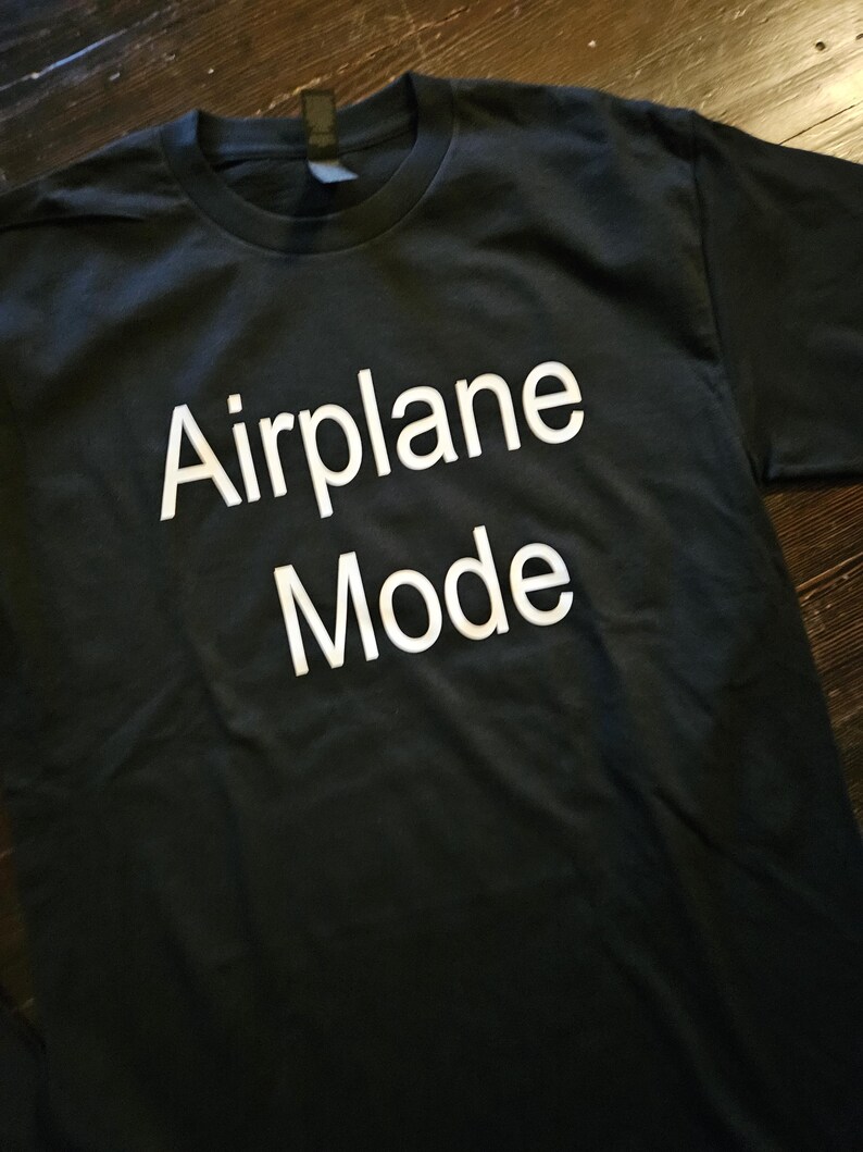 May include: Black t-shirt with white text that reads "Airplane Mode".