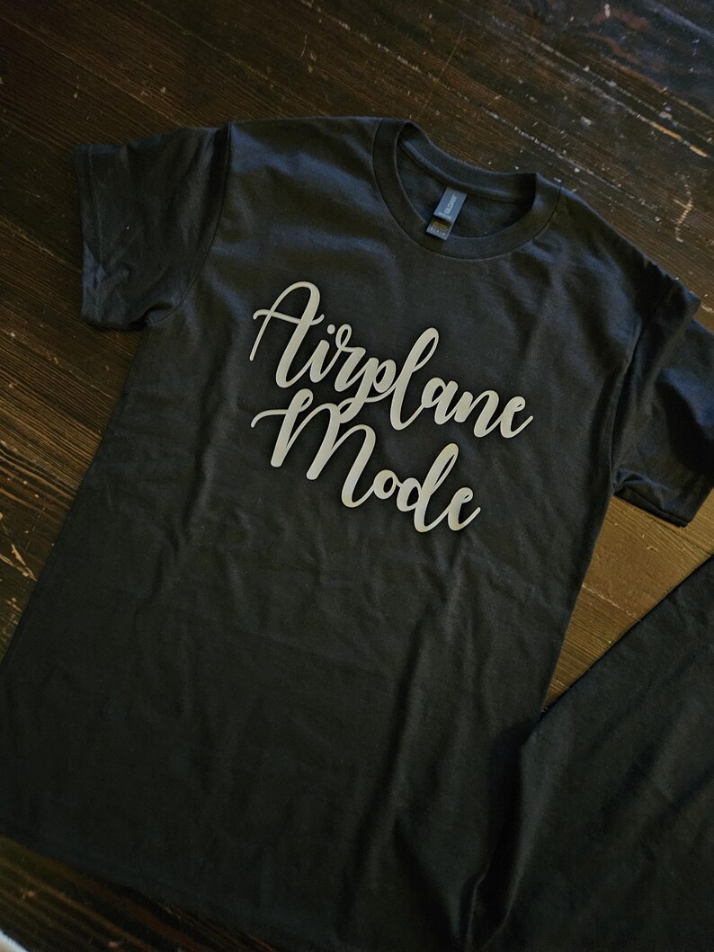 May include: A black t-shirt with the text "Airplane Mode" printed in white on the front.