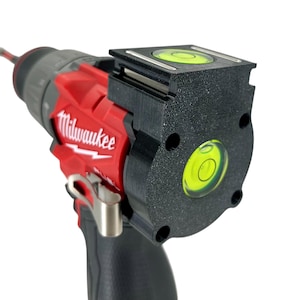 May include: A red and black Milwaukee drill with a black level attachment. The level has a bubble and is designed to help ensure accurate drilling. The drill is shown against a white background.