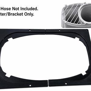 May include: A black plastic dual hose adapter bracket for an air conditioner, featuring a rectangular frame with a central oval cutout. The text "Duel Hose Not Included. Adapter/Bracket Only." is visible, along with an inset showing a white hose.