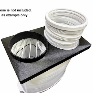 May include: A black rectangular adapter plate with two circular openings, one featuring a black rim and a white wire grid, and the other attached to a white flexible accordion-style hose. Text reads: Duel Hose is not included. Shown as example only.
