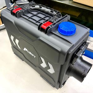 May include: A black and gray portable heater with a blue cap and red accents. The heater has a handle and the brand name "Ncalory" printed on the side. It features a black exhaust port.