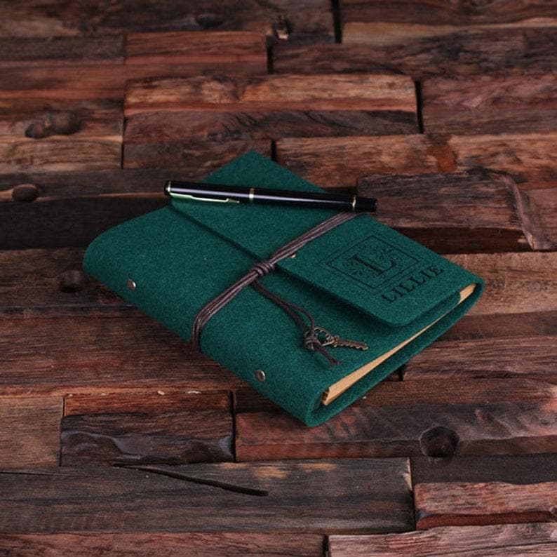 May include: A green felt journal with a brown leather strap and a key charm. The journal has a personalized name, "Lillie", embossed on the front cover.
