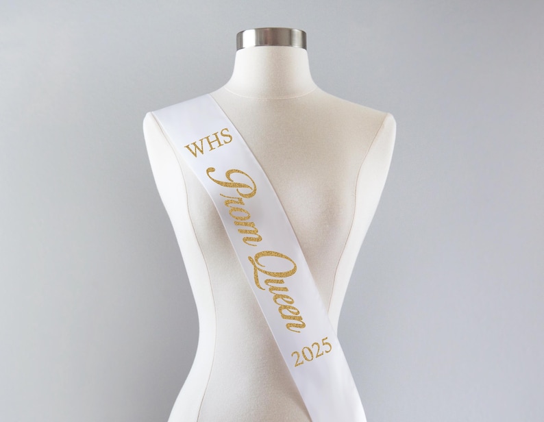 May include: White satin sash with gold glitter lettering that reads "WHS Prom Queen 2025".