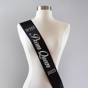May include: Black satin sash with silver glitter lettering that reads "WHS Prom Queen 2025".