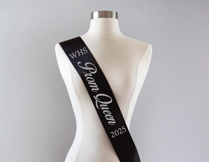 May include: Black satin sash with silver glitter lettering that reads "WHS Prom Queen 2025".