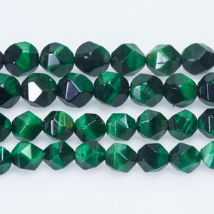 May include: A strand of green faceted gemstone beads. The beads are round and have a starburst pattern.