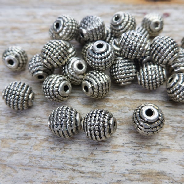 bohemian style silver beads - patterned barrel metal beads - antique silver bicone beads - antique style jewelry materials - alloy beads