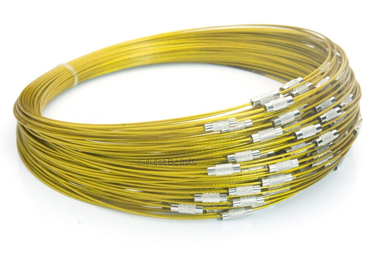 May include: A coil of gold-colored wire with silver-colored end caps. The wire is coiled in a circle and is about 10 inches in diameter.