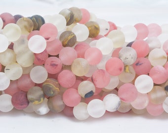 May include: A strand of round, frosted gemstone beads in shades of pink, white, and brown. The beads have a translucent appearance and are approximately 10mm in diameter.