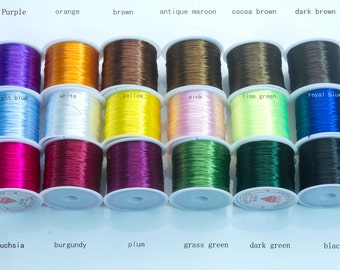 May include: Spools of colorful elastic cord in various shades, including purple, orange, brown, and black. The image displays a range of colors with labels such as "fuchsia," "burgundy," and "grass green." Ideal for crafting and jewelry making.